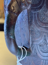 A Chinese archaic bronze inscribed wine vessel with scale design, 'hu 壺', Zhou