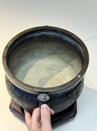 A Chinese archaistic bronze censer with 'chilong' and 'lingzhi' handles on wooden stand, Zhou Wang Bo Zuo Bao Ding 周王伯作寶鼎 mark, Yuan/Ming