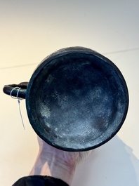 A Chinese archaic bronze inscribed wine vessel with scale design, 'hu 壺', Zhou