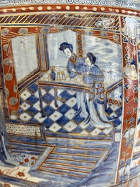A large Chinese European-decorated blue and white fish bowl with narrative design, on a later wooden stand, Kangxi