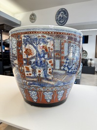 A large Chinese European-decorated blue and white fish bowl with narrative design, on a later wooden stand, Kangxi
