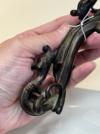 A Chinese bronze 'dragon' brush rest, Song/Yuan