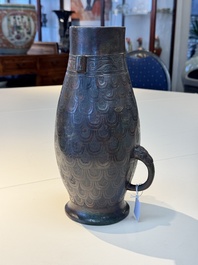 A Chinese archaic bronze inscribed wine vessel with scale design, 'hu 壺', Zhou