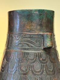 A Chinese archaic bronze inscribed wine vessel with scale design, 'hu 壺', Zhou