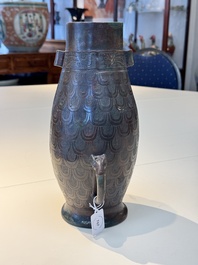 A Chinese archaic bronze inscribed wine vessel with scale design, 'hu 壺', Zhou