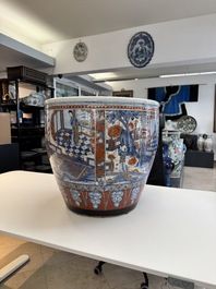 A large Chinese European-decorated blue and white fish bowl with narrative design, on a later wooden stand, Kangxi