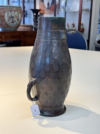 A Chinese archaic bronze inscribed wine vessel with scale design, 'hu 壺', Zhou