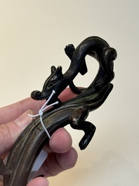 A Chinese bronze 'dragon' brush rest, Song/Yuan
