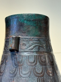 A Chinese archaic bronze inscribed wine vessel with scale design, 'hu 壺', Zhou