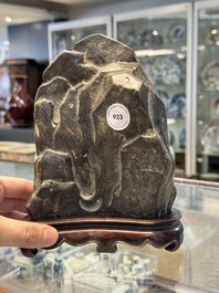 A Chinese Lingbi stone scholar's rock on wooden stand, Yun Tai 雲台 mark, 19/20th C.