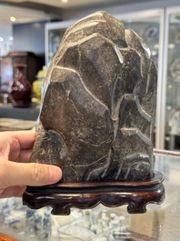 A Chinese Lingbi stone scholar's rock on wooden stand, Yun Tai 雲台 mark, 19/20th C.