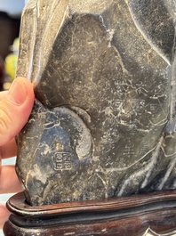 A Chinese Lingbi stone scholar's rock on wooden stand, Yun Tai 雲台 mark, 19/20th C.
