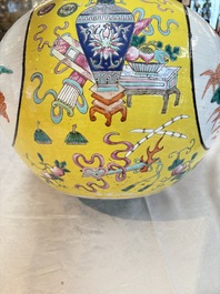 A large Chinese famille rose yellow-ground 'tianqiu ping' vase with flowers and antiquities, 19th C.