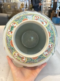 A pair of Chinese famille verte 'birds and flowers' vases and covers, 19th C.