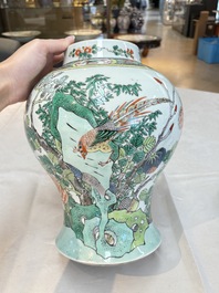 A pair of Chinese famille verte 'birds and flowers' vases and covers, 19th C.