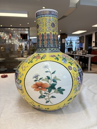 A large Chinese famille rose yellow-ground 'tianqiu ping' vase with flowers and antiquities, 19th C.