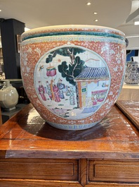A large Chinese famille rose coral-red-ground fish bowl with narrative design, 19th C.