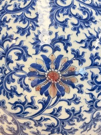 A Chinese blue, white and copper-red 'hu' vase with lotus scrolls, Qianlong mark, 19th C.