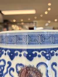 A Chinese blue, white and copper-red 'hu' vase with lotus scrolls, Qianlong mark, 19th C.