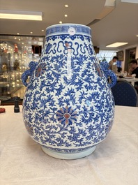 A Chinese blue, white and copper-red 'hu' vase with lotus scrolls, Qianlong mark, 19th C.