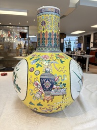 A large Chinese famille rose yellow-ground 'tianqiu ping' vase with flowers and antiquities, 19th C.