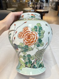 A pair of Chinese famille verte 'birds and flowers' vases and covers, 19th C.
