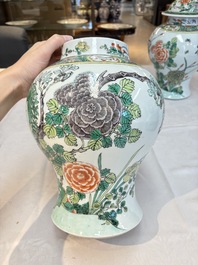 A pair of Chinese famille verte 'birds and flowers' vases and covers, 19th C.