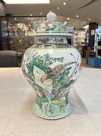 A pair of Chinese famille verte 'birds and flowers' vases and covers, 19th C.