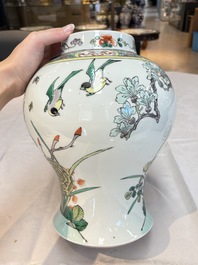 A pair of Chinese famille verte 'birds and flowers' vases and covers, 19th C.