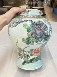 A pair of Chinese famille verte 'birds and flowers' vases and covers, 19th C.