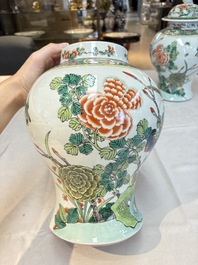 A pair of Chinese famille verte 'birds and flowers' vases and covers, 19th C.