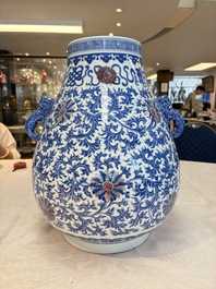 A Chinese blue, white and copper-red 'hu' vase with lotus scrolls, Qianlong mark, 19th C.