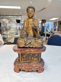 A set of three Chinese or Vietnamese gilt-lacquered wooden sculptures of Buddha, 18/19th C.