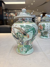 A pair of Chinese famille verte 'birds and flowers' vases and covers, 19th C.