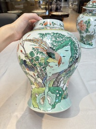A pair of Chinese famille verte 'birds and flowers' vases and covers, 19th C.