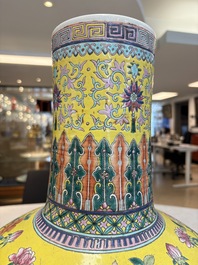 A large Chinese famille rose yellow-ground 'tianqiu ping' vase with flowers and antiquities, 19th C.