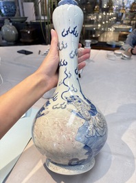 A Chinese blue, white and copper-red garlic-mouth vase with mythical animals, Kangxi mark, 19th C.