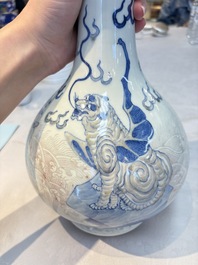 A Chinese blue, white and copper-red garlic-mouth vase with mythical animals, Kangxi mark, 19th C.