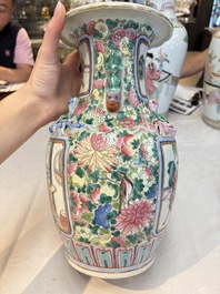 A pair of Chinese famille rose vases with narrative design on wooden stands, 19th C.