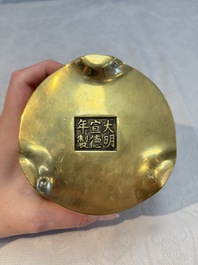 A Chinese bronze cylindrical tripod censer, Xuande mark, 18th C.