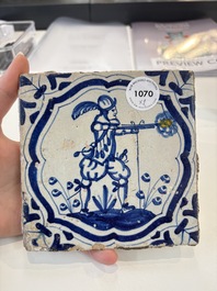 Two blue and white Dutch Delft 'soldier with coloured flame' tiles, 17th C.