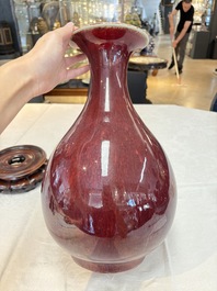 A large Chinese flamb&eacute;-glazed 'yuhuchunping' vase on a wooden stand, 19th C.