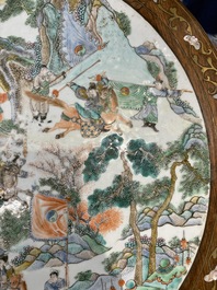 A Chinese mother-of-pearl-inlaid hongmu table with a circular Canton famille verte 'warriors on horseback' plaque, 19th C.