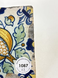 Two small polychrome Dutch Delft 'pomegranates' and 'tulips' tiles, ca. 1600