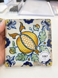 Two small polychrome Dutch Delft 'pomegranates' and 'tulips' tiles, ca. 1600