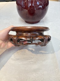 A large Chinese flamb&eacute;-glazed 'yuhuchunping' vase on a wooden stand, 19th C.