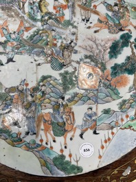 A Chinese mother-of-pearl-inlaid hongmu table with a circular Canton famille verte 'warriors on horseback' plaque, 19th C.