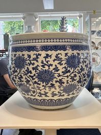 A massive Chinese blue and white 'lotus scroll' fish bowl, Qianlong/Jiaqing