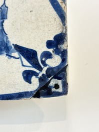 Two blue and white Dutch Delft 'castle' and 'soldier with coloured flame' tiles, 17th C.