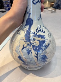 A Chinese blue, white and copper-red garlic-mouth vase with mythical animals, Kangxi mark, 19th C.